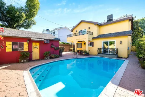 a view of a house with swimming pool and sitting area