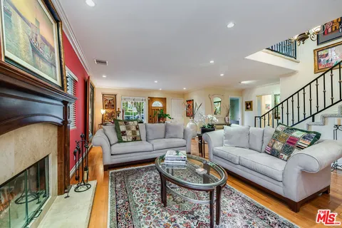 a living room with furniture a fireplace and a window