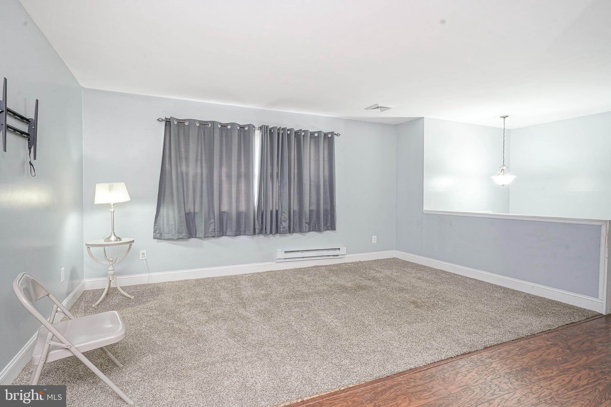 1304 Morgan Road Williamstown, NJ 08094 - Photo 16 of 32 an empty room with wooden floor and windows