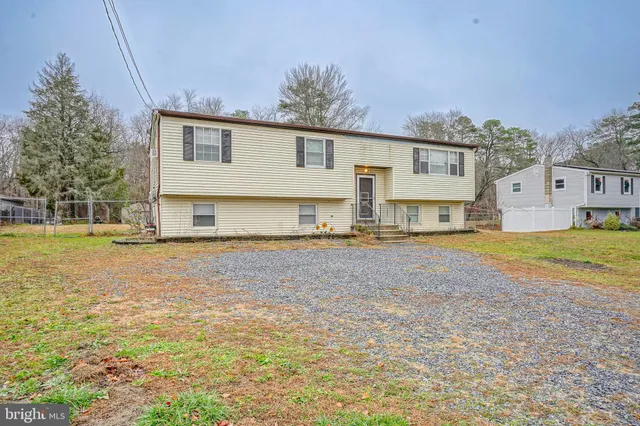 a view of a house with a yard and sitting area