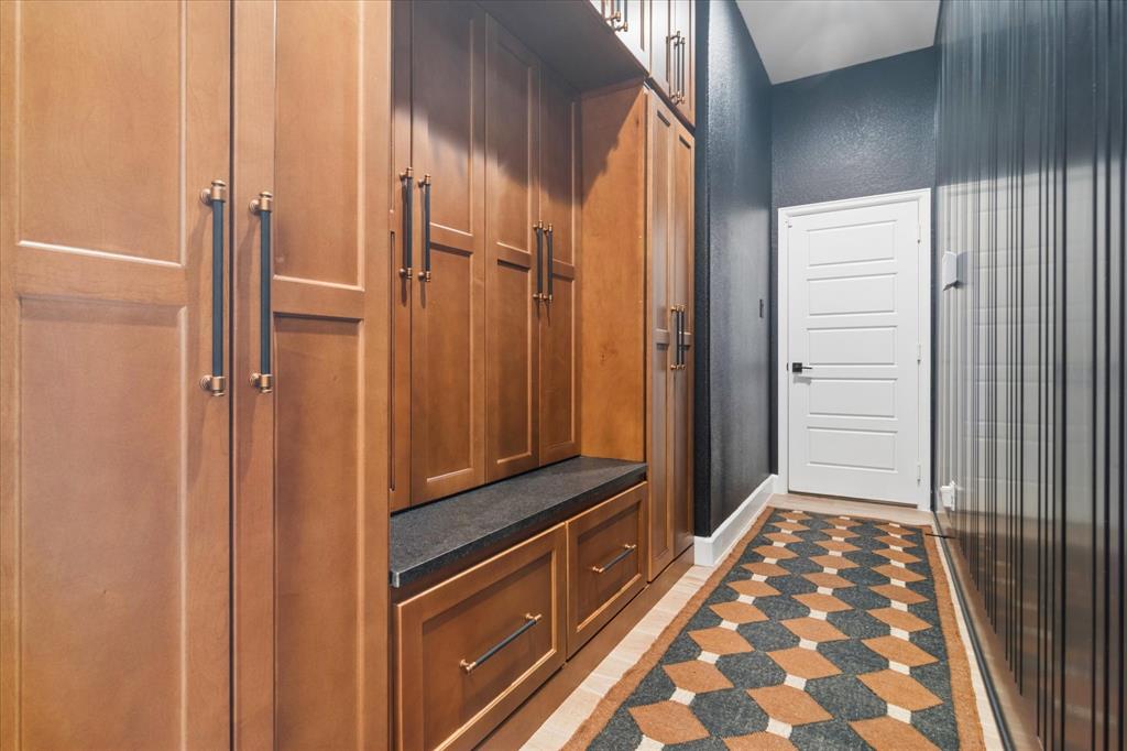 582 Broadleaf Way Haslet, TX 76052 - Photo 29 of 40 Fabulous mudroom just off of the garage with custom stained cabinetry, marble seating, drawers below, so much storage, even above to the ceiling. Custom accent wall.