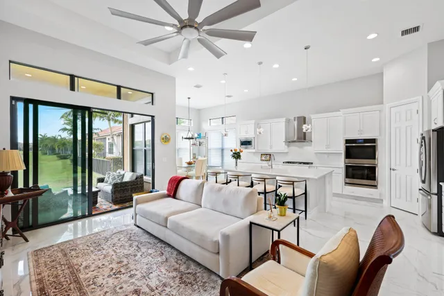 a kitchen with kitchen island white cabinets and stainless steel appliances