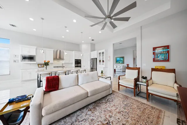 a kitchen with granite countertop a table chairs refrigerator and microwave