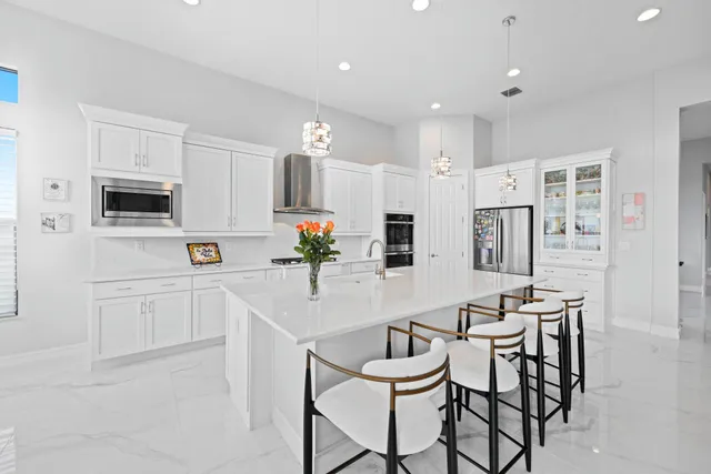 a kitchen with stainless steel appliances kitchen island granite countertop a sink and cabinets