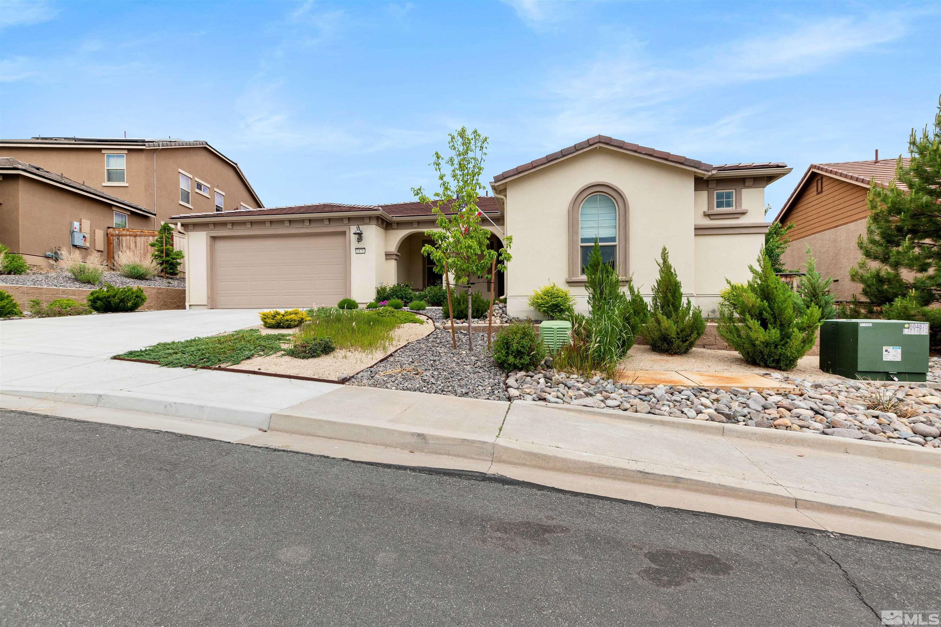 a front view of a house with a yard and a garage