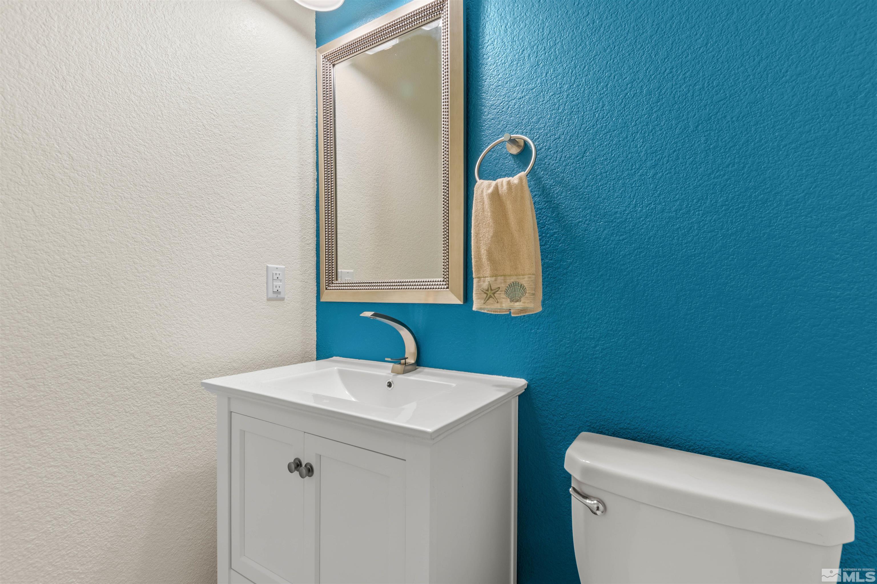 1876 Scott Valley Road Reno, NV 89523 - Photo 13 of 31 a bathroom with a toilet a sink and mirror