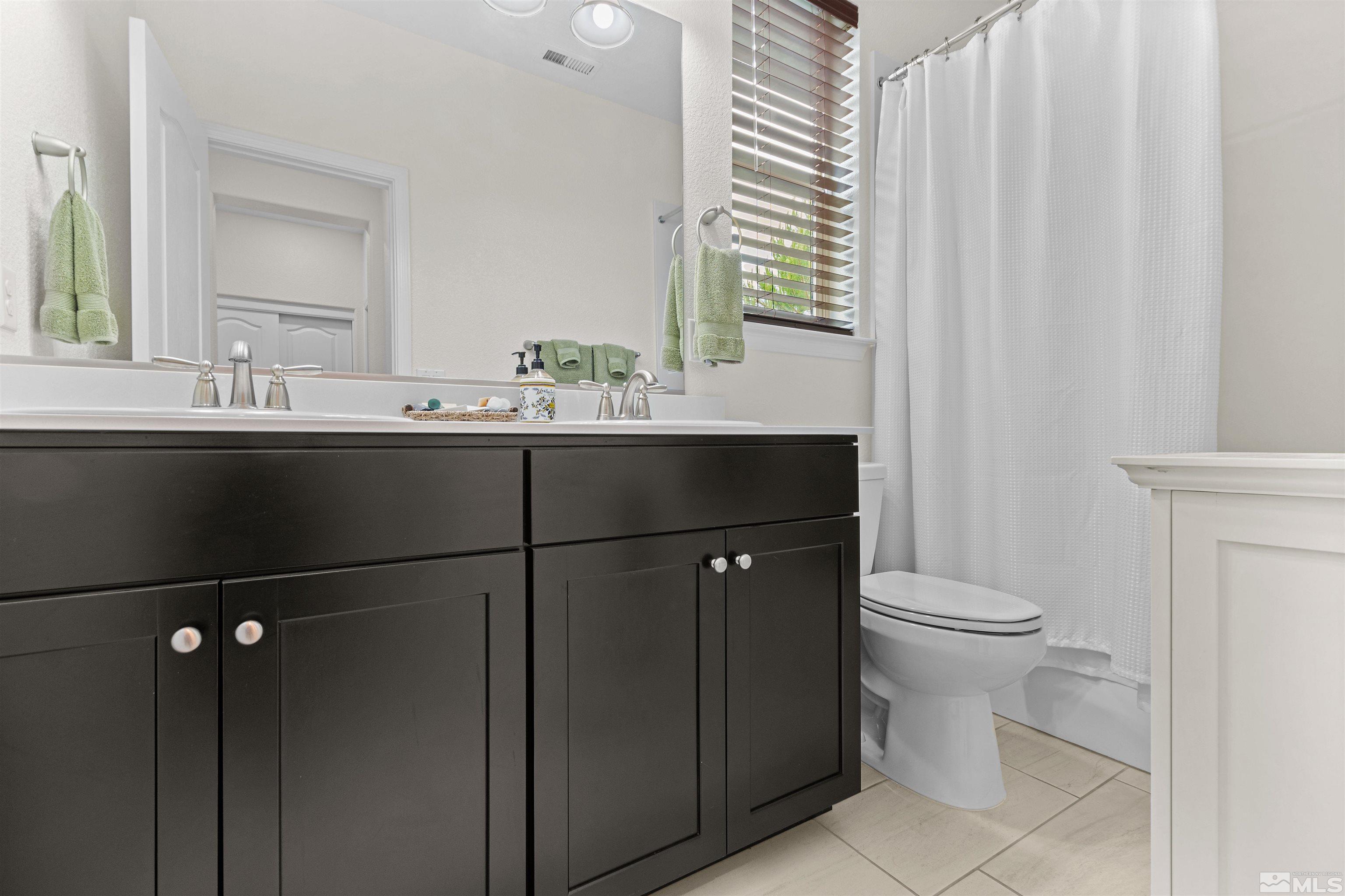 1876 Scott Valley Road Reno, NV 89523 - Photo 20 of 31 a bathroom with a sink a toilet and mirror