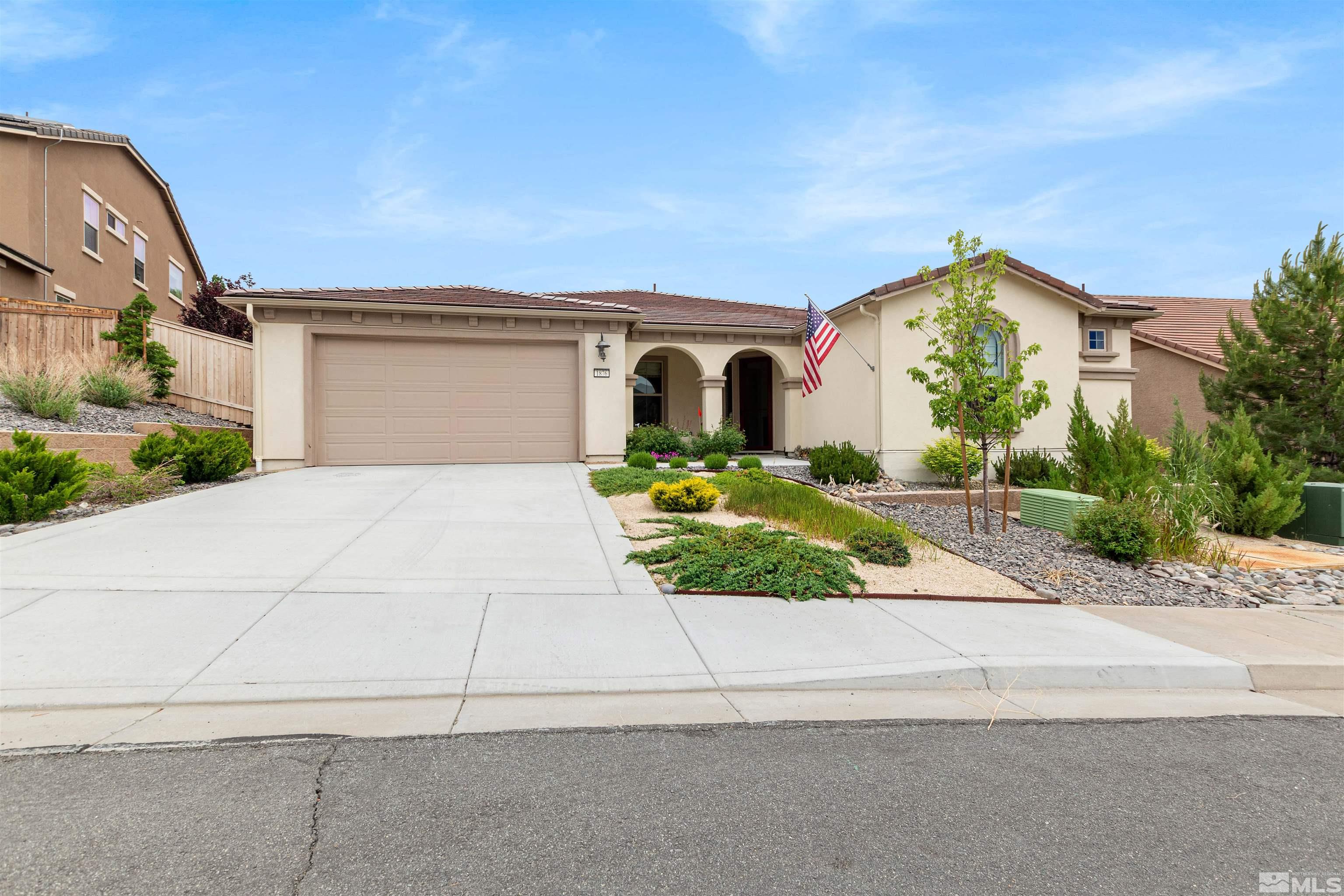 1876 Scott Valley Road Reno, NV 89523 - Photo 2 of 31 a front view of a house with a yard and garage