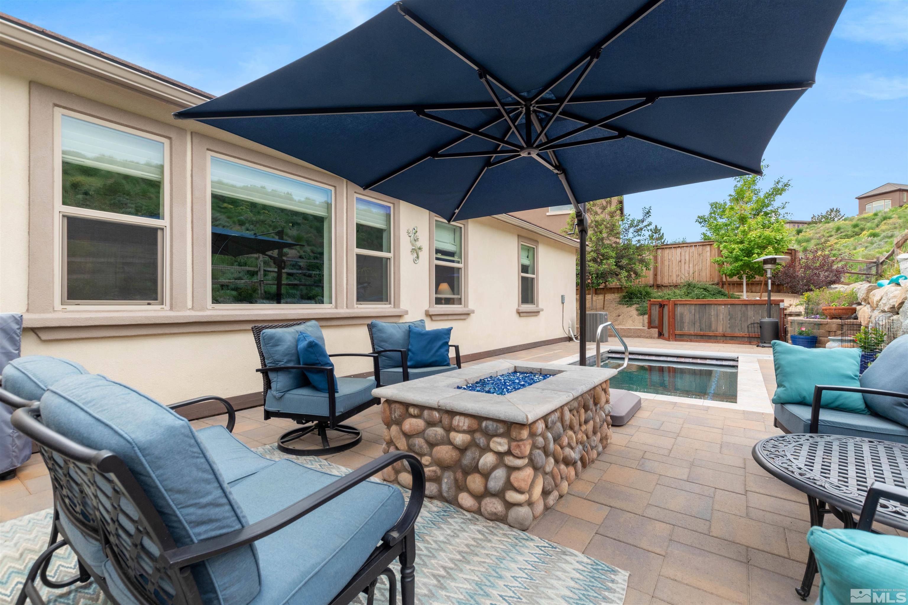 1876 Scott Valley Road Reno, NV 89523 - Photo 26 of 31 a outdoor space with patio the couches and pool with an umbrella
