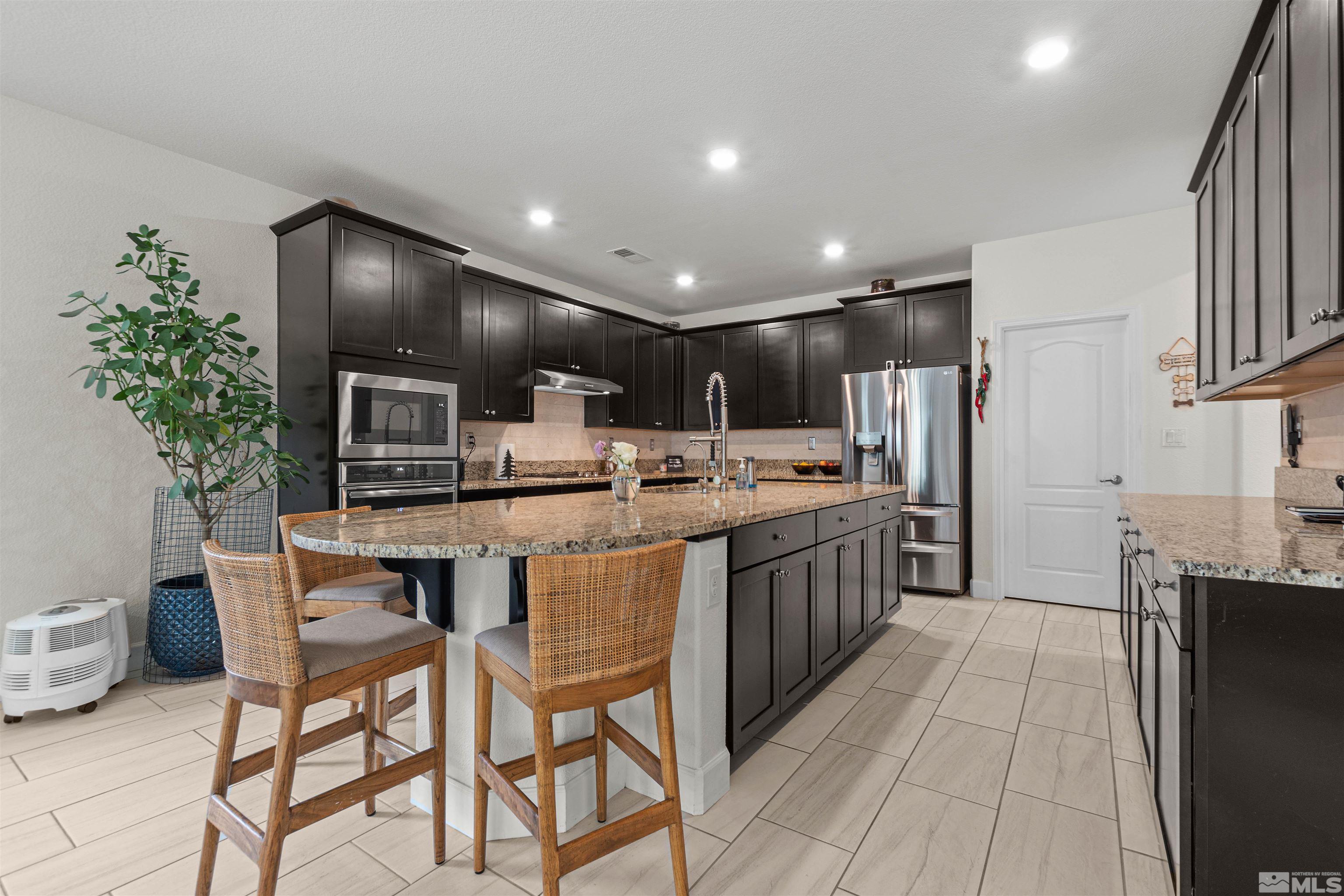 1876 Scott Valley Road Reno, NV 89523 - Photo 9 of 31 a kitchen with stainless steel appliances kitchen island granite countertop a sink and cabinets