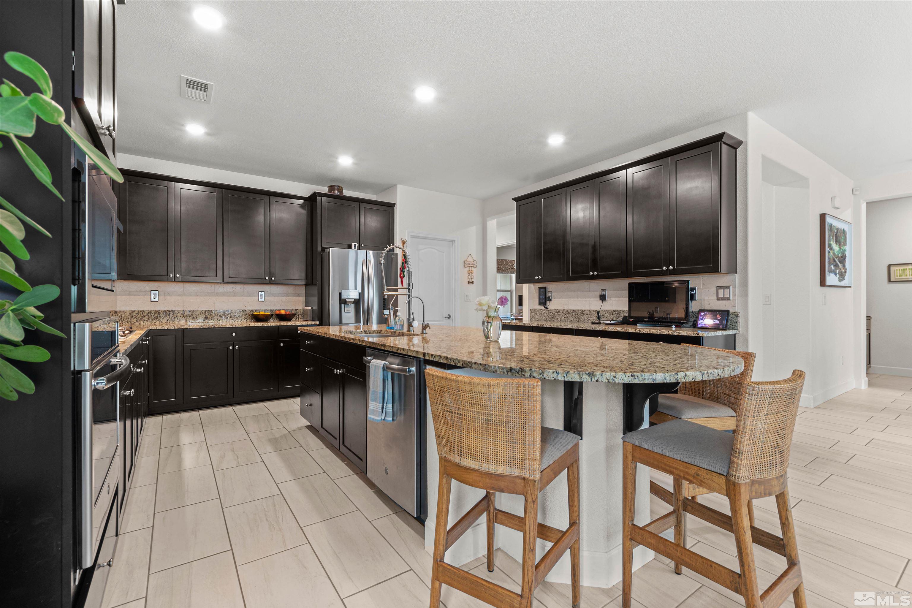 1876 Scott Valley Road Reno, NV 89523 - Photo 10 of 31 a kitchen with kitchen island granite countertop lots of counter top space and stainless steel appliances