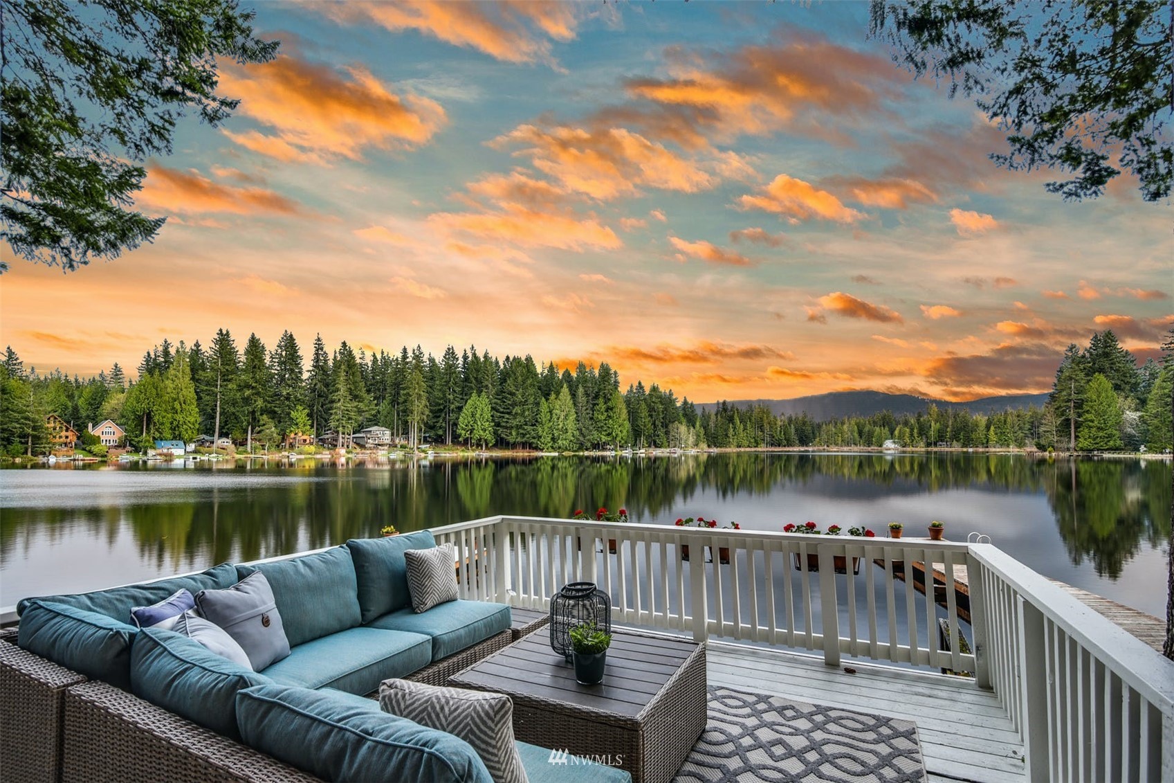 a balcony with wooden floor and lake view