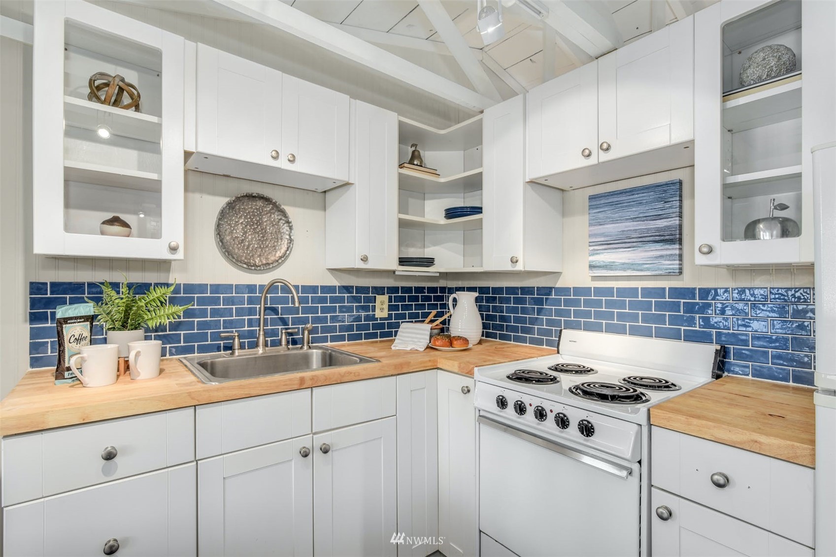 7327 Lake Alice Road Southeast Fall City, WA 98024 - Photo 21 of 35 a kitchen with a sink stove and cabinets