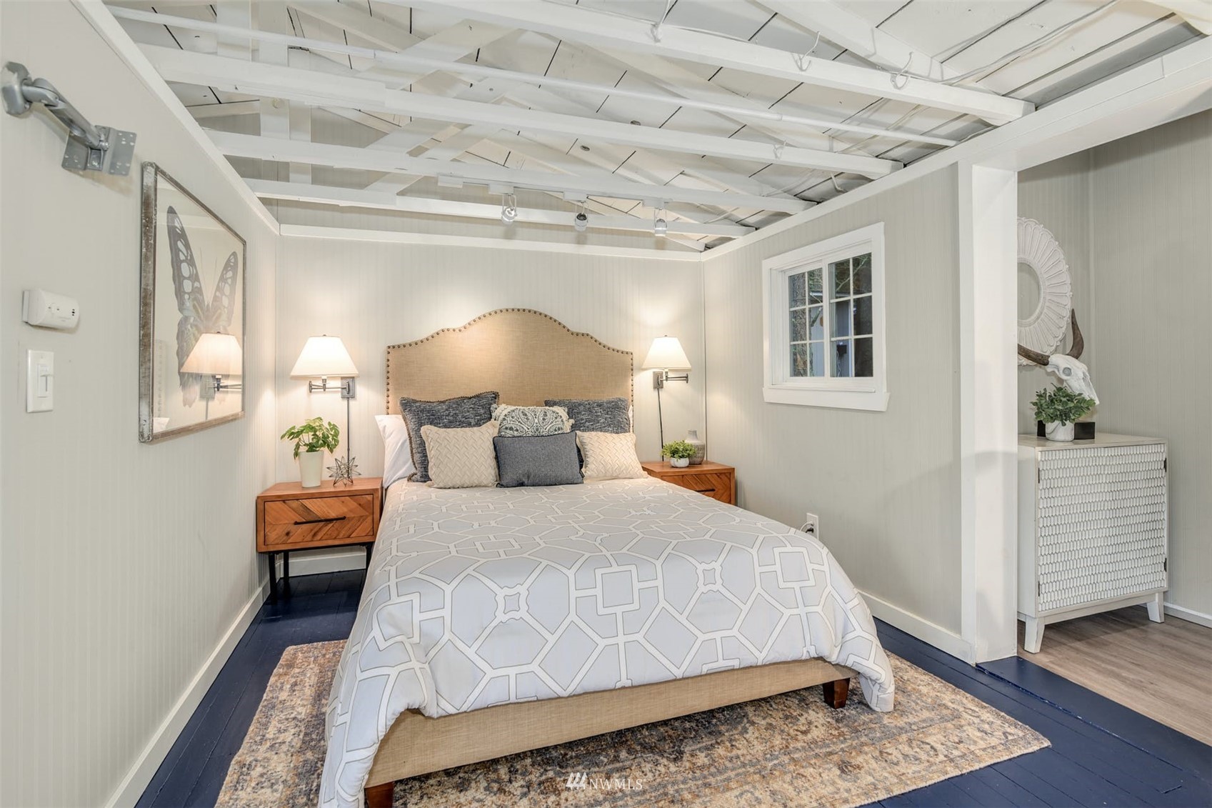 7327 Lake Alice Road Southeast Fall City, WA 98024 - Photo 24 of 35 a bedroom with a large bed and a chandelier