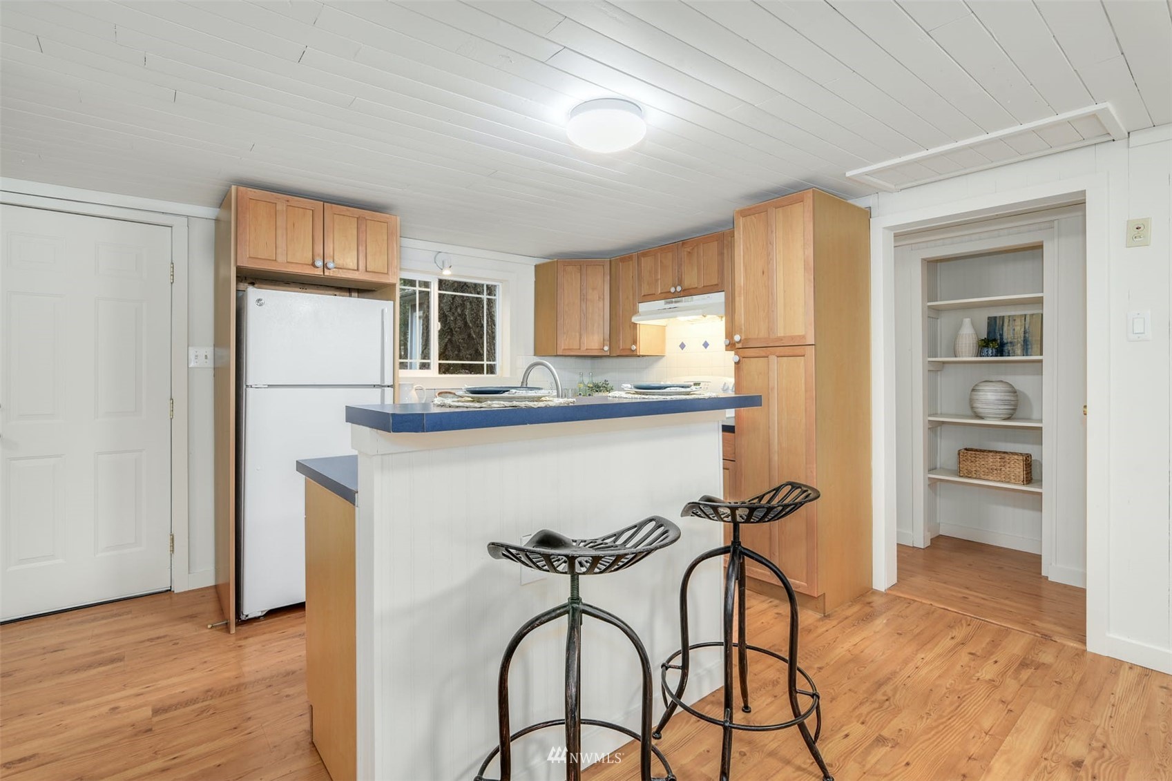 7327 Lake Alice Road Southeast Fall City, WA 98024 - Photo 8 of 35 a kitchen with stainless steel appliances granite countertop a dining table chairs refrigerator and sink