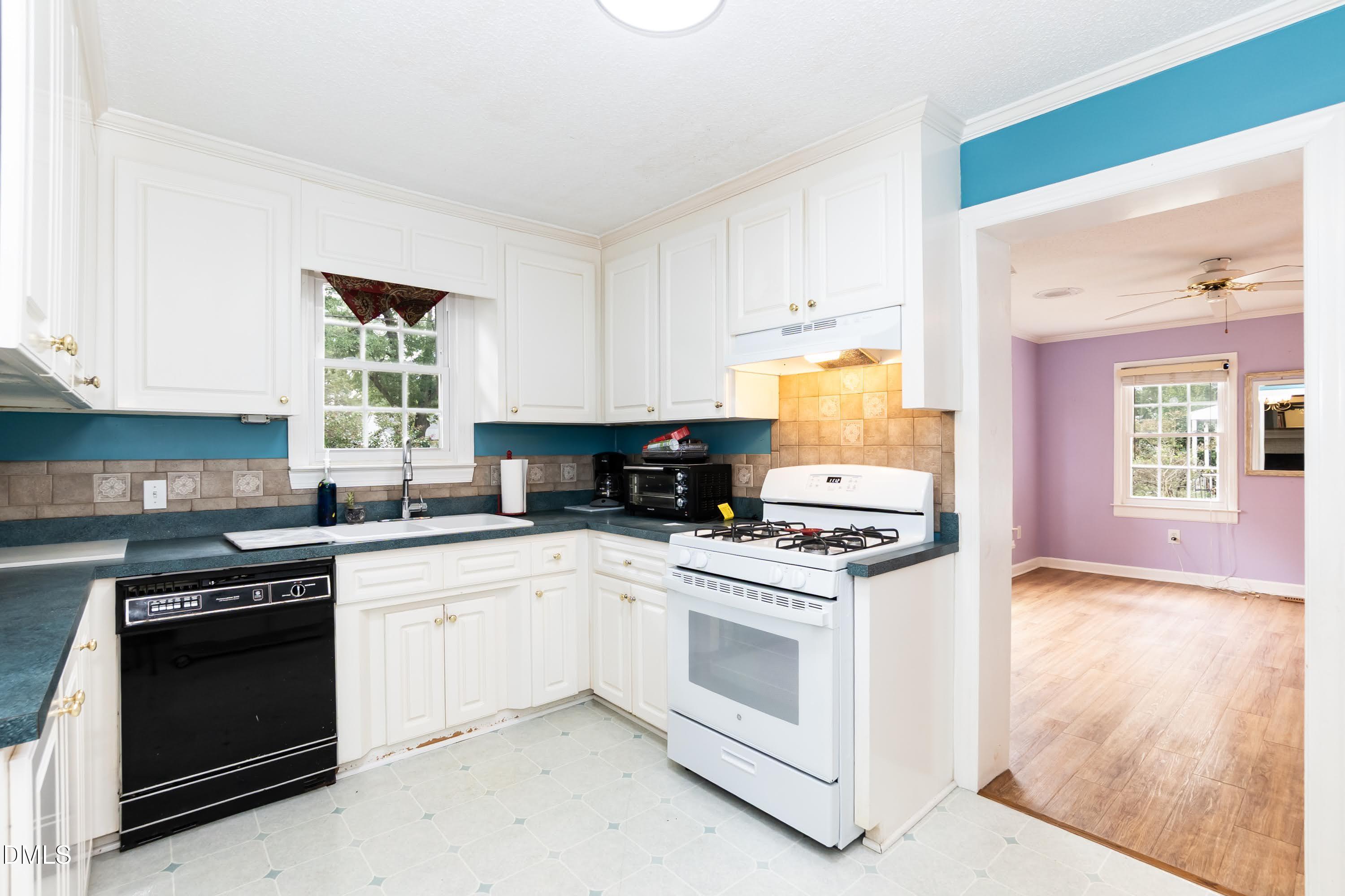 700 St Marys Street Garner, NC 27529 - Photo 16 of 51 a kitchen with white cabinets and white appliances