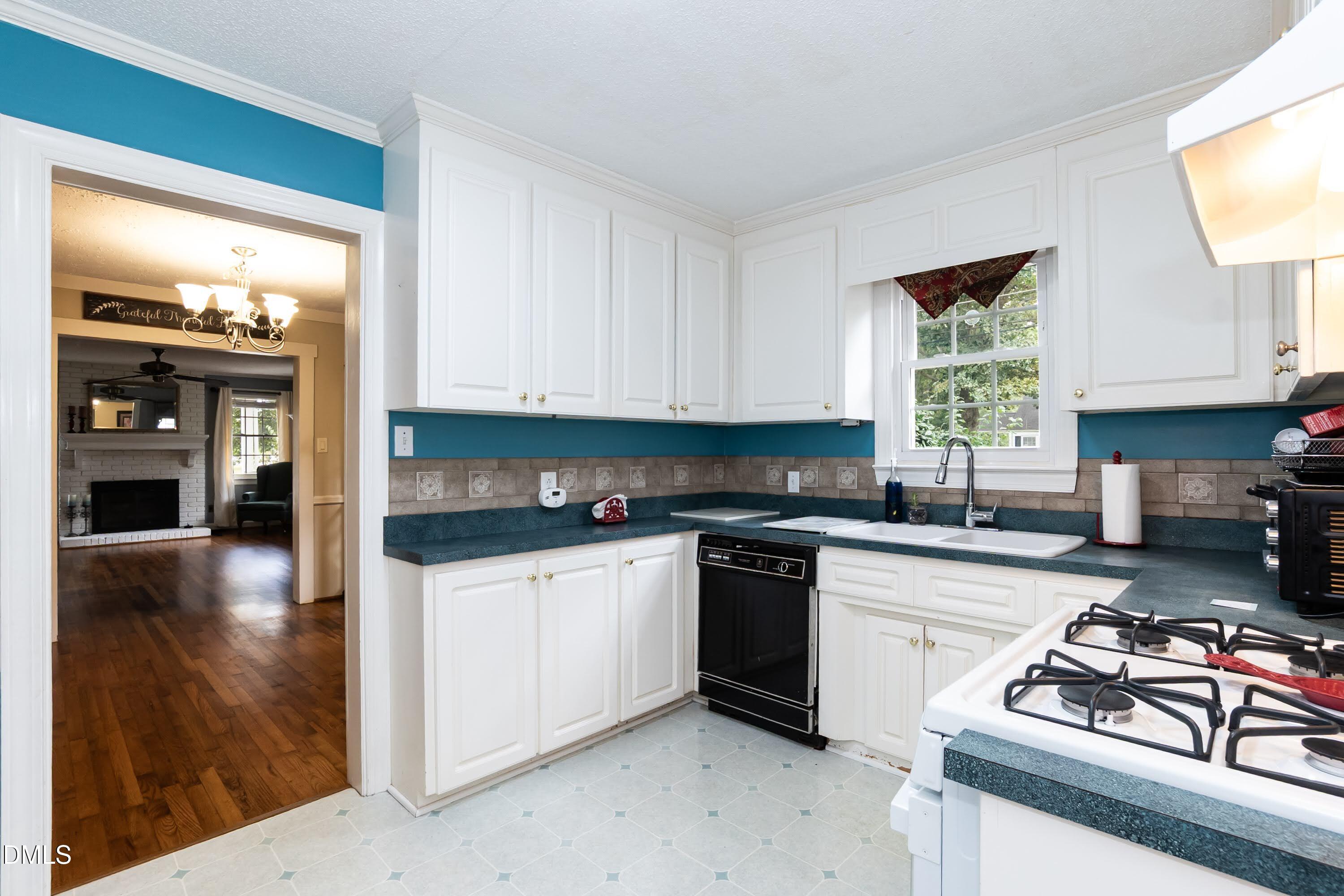 700 St Marys Street Garner, NC 27529 - Photo 18 of 51 a kitchen with stainless steel appliances granite countertop a stove a sink and a microwave