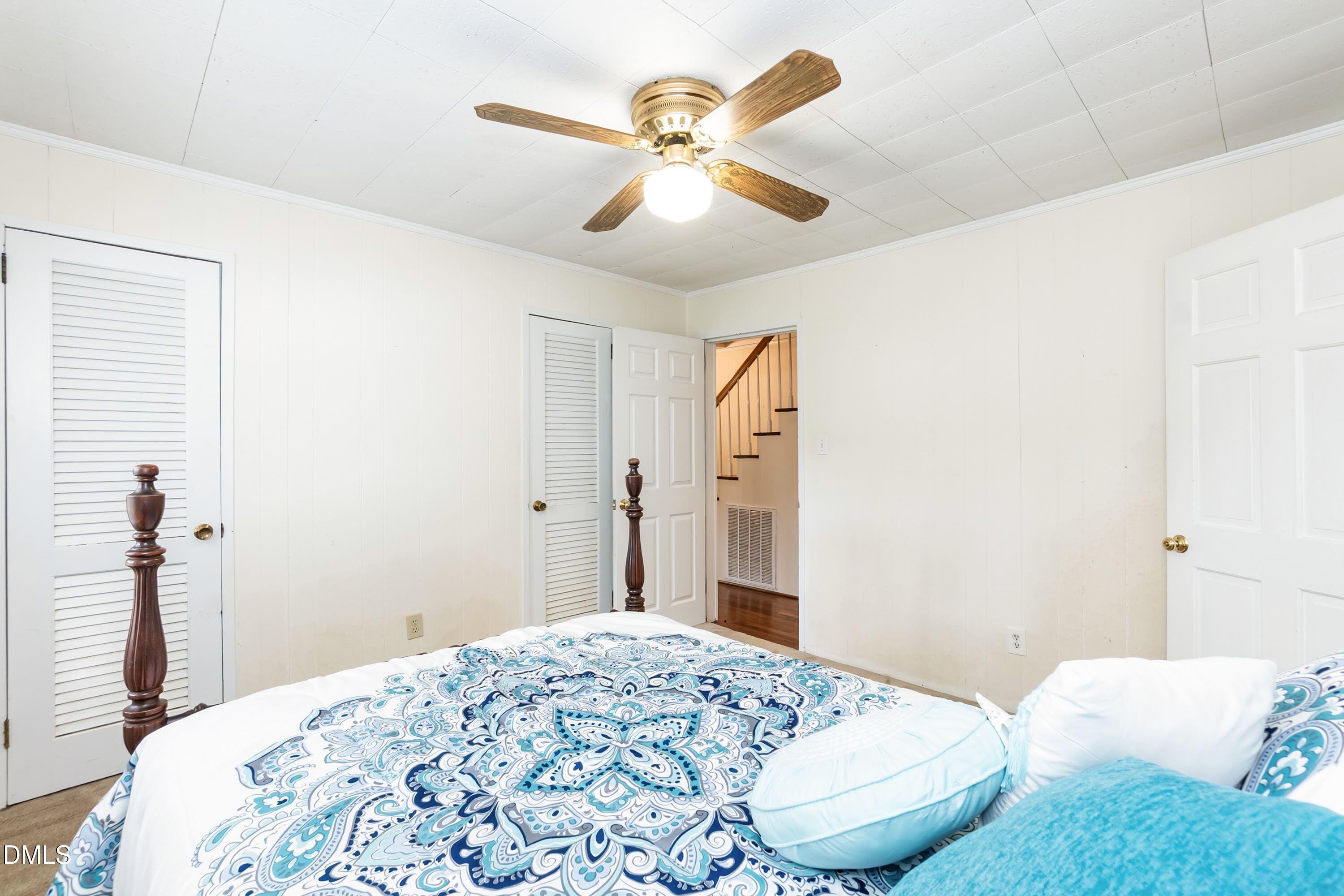 700 St Marys Street Garner, NC 27529 - Photo 25 of 51 a bedroom with a bed and a chandelier