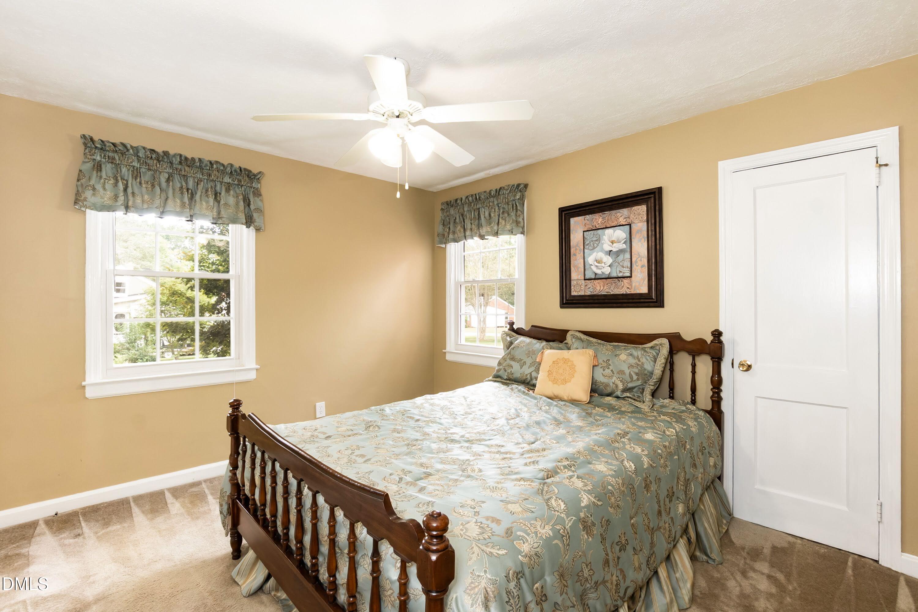 700 St Marys Street Garner, NC 27529 - Photo 28 of 51 a bedroom with a bed and a chandelier