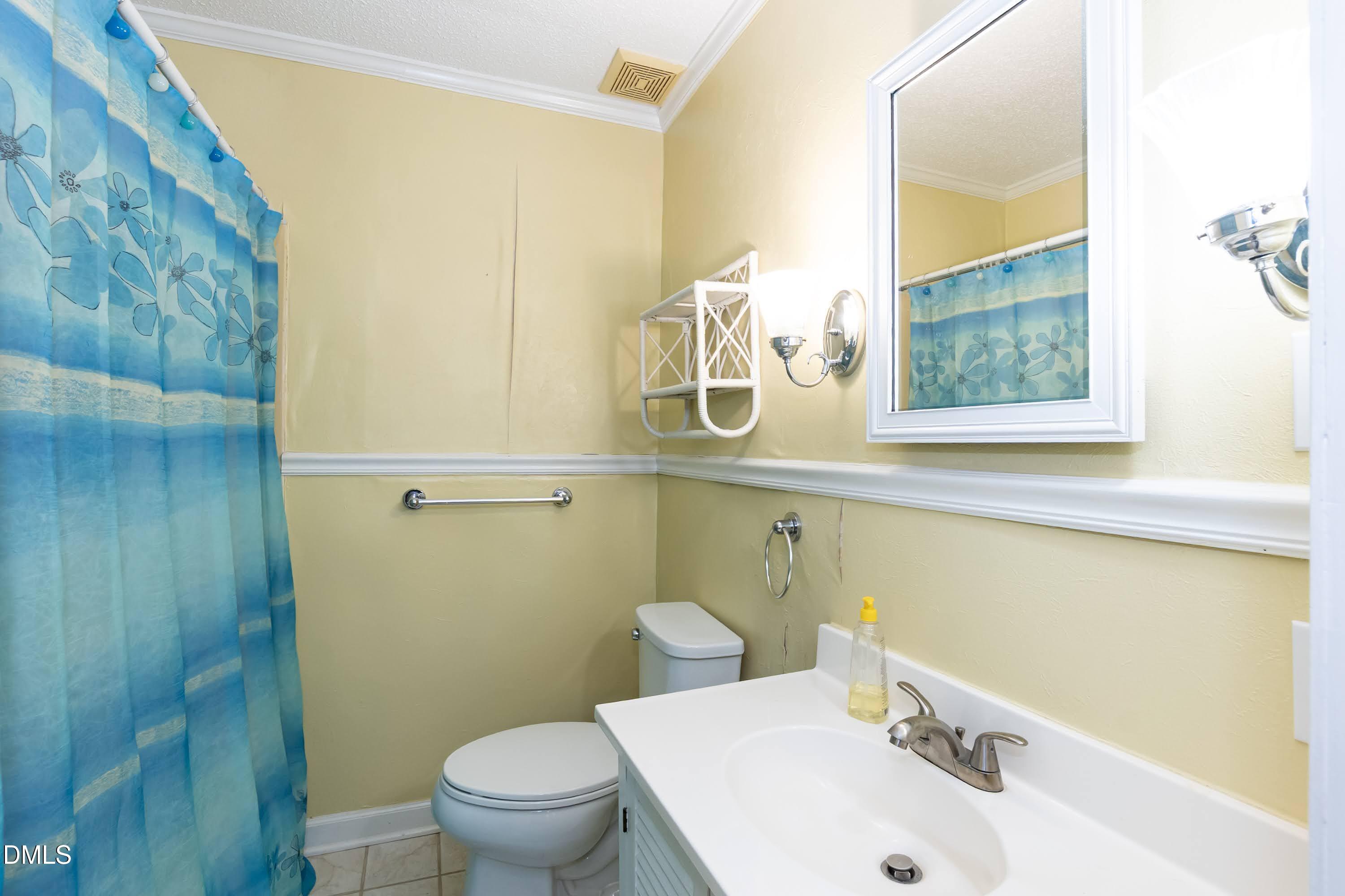 700 St Marys Street Garner, NC 27529 - Photo 30 of 51 a bathroom with a sink and a mirror