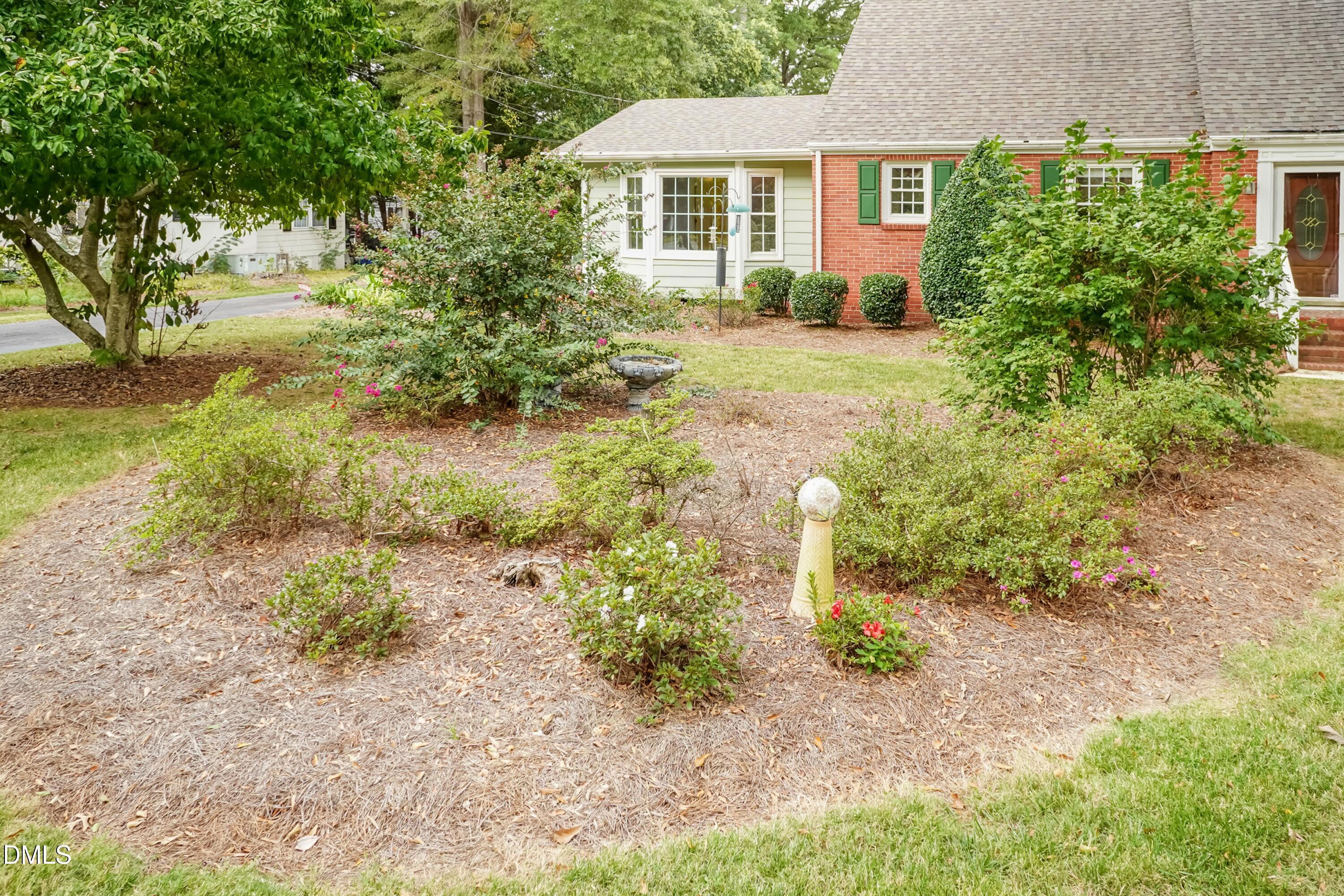 700 St Marys Street Garner, NC 27529 - Photo 43 of 51 a view of a yard with plants and large trees
