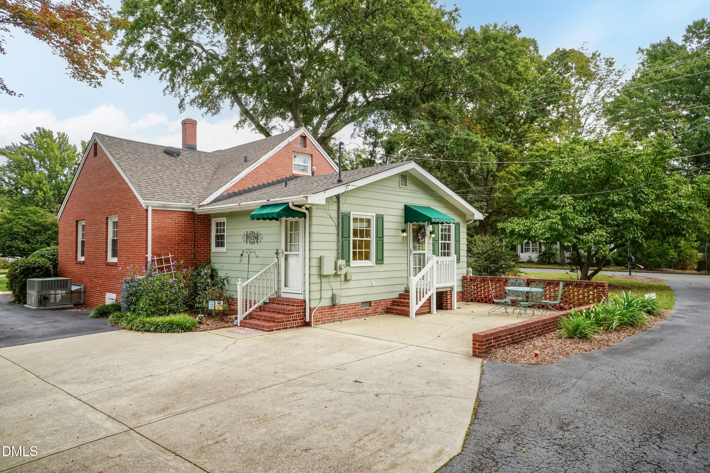 700 St Marys Street Garner, NC 27529 - Photo 49 of 51 a patio with a table and chairs under an umbrella