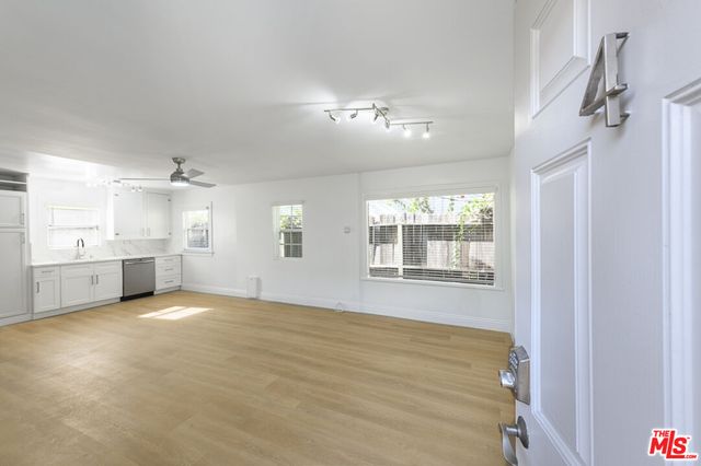 a view of an empty room with a kitchen
