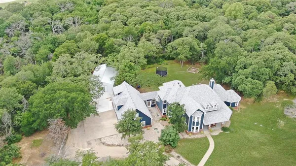 an aerial view of a house with outdoor space and street view
