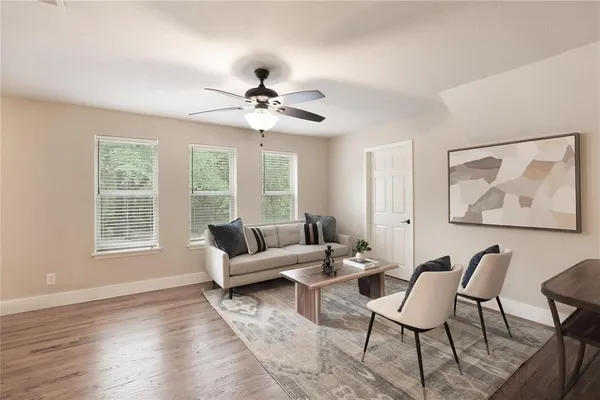 a living room with furniture a chandelier and a window