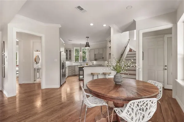 a dining room with furniture and wooden floor