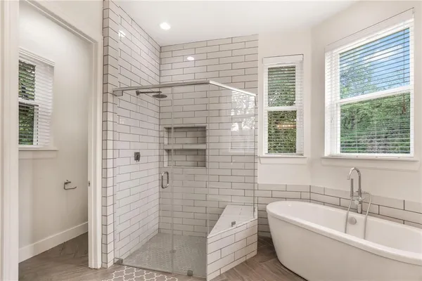 a bathroom with a bathtub and window