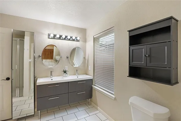 a bathroom with a sink toilet and shower