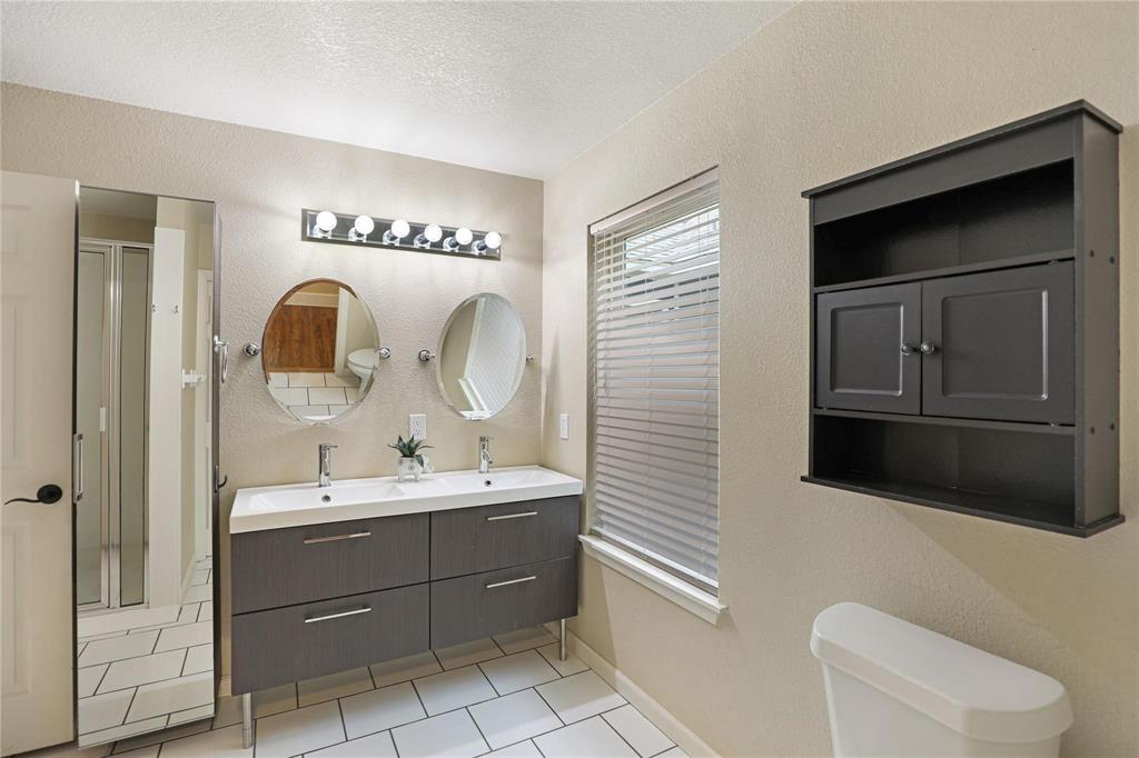1751 Spring Mountain Road Cross Roads, TX 76227 - Photo 32 of 38 a bathroom with a sink a toilet and a mirror
