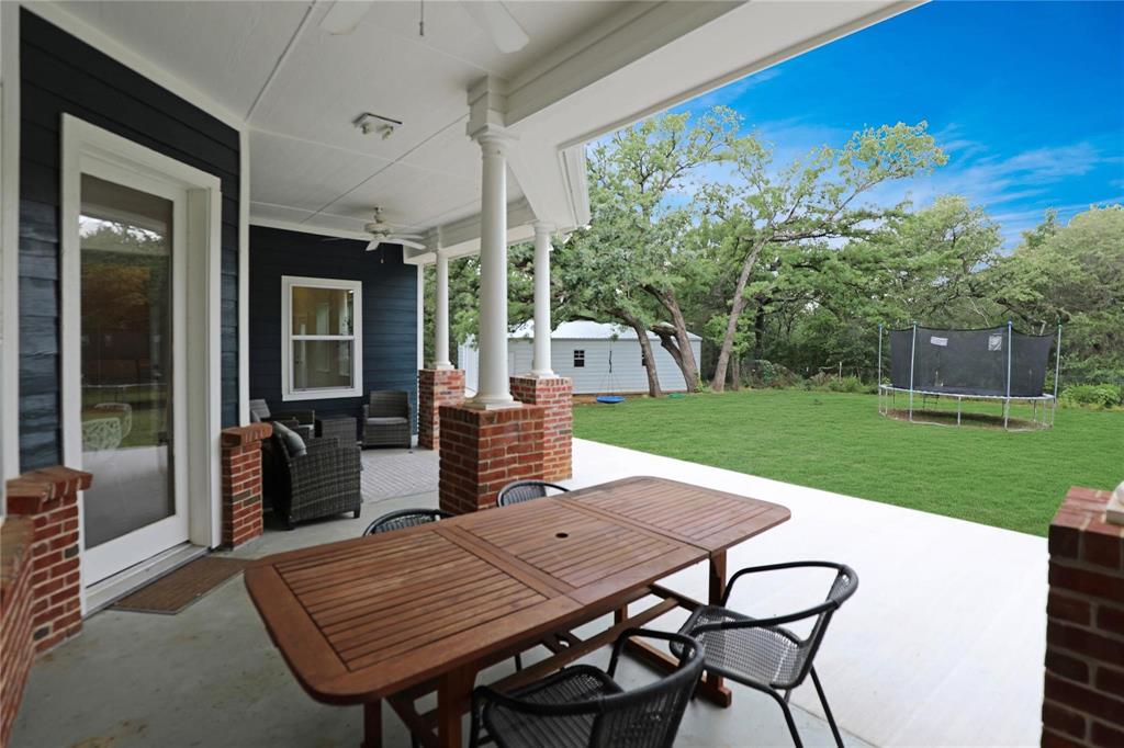 1751 Spring Mountain Road Cross Roads, TX 76227 - Photo 35 of 38 a view of a backyard with furniture and garden