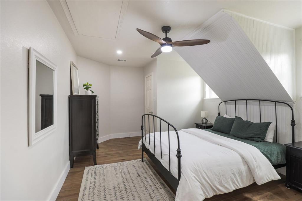 1751 Spring Mountain Road Cross Roads, TX 76227 - Photo 38 of 38 a bedroom with a large bed and a chandelier