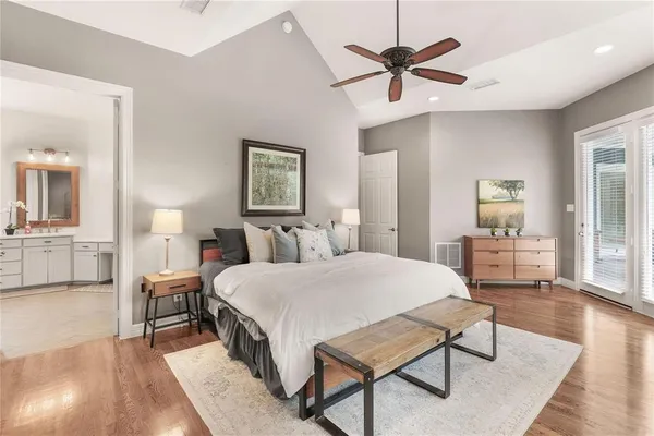 a spacious bedroom with a bed and a chandelier
