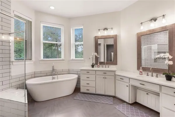 a spacious bathroom with sink double vanity and mirror