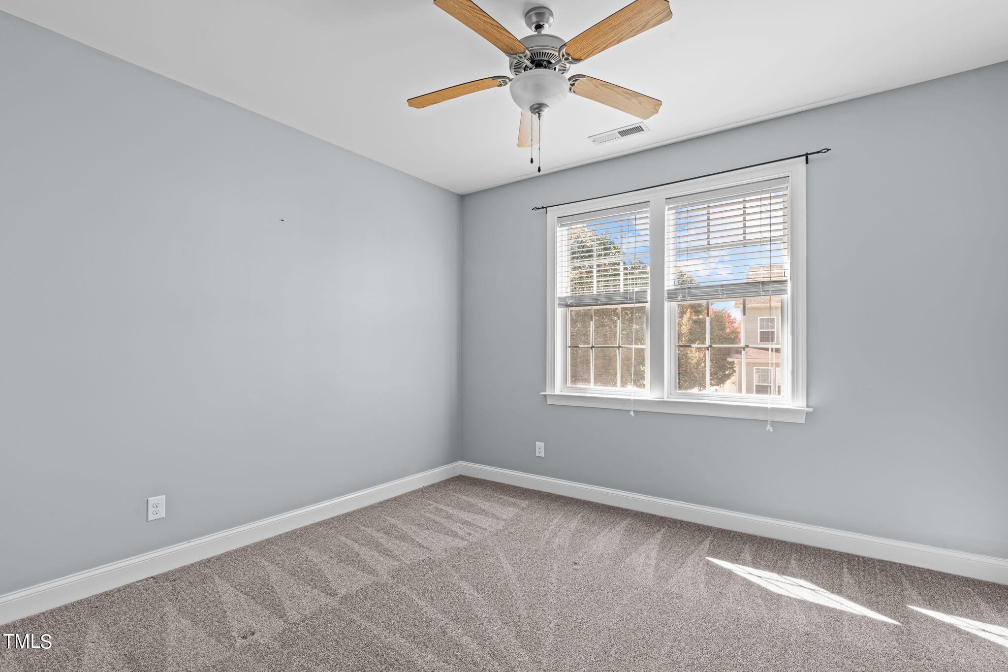 601 Democracy Street Raleigh, NC 27603 - Photo 19 of 24 an empty room with a window and a fan
