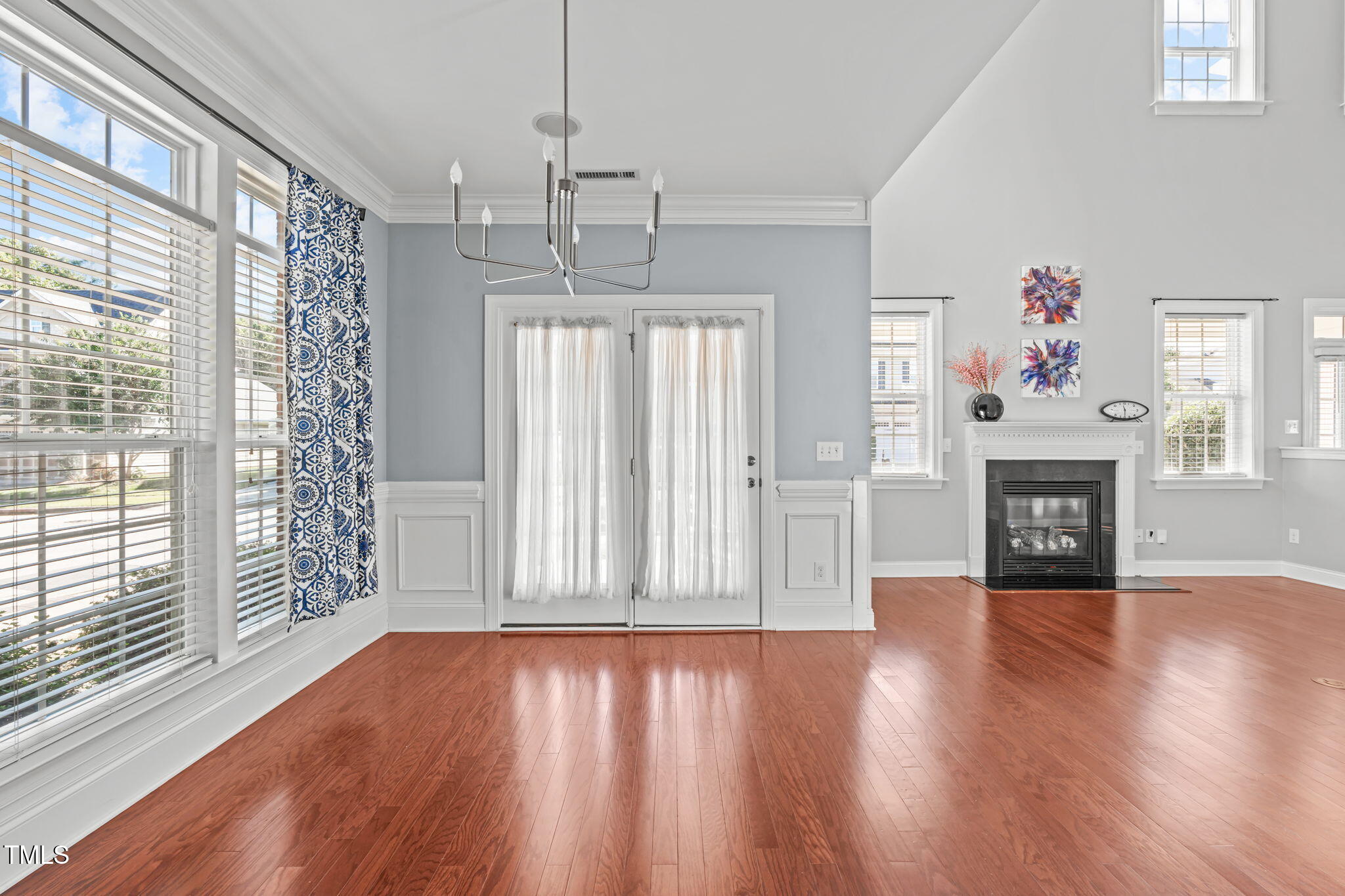 601 Democracy Street Raleigh, NC 27603 - Photo 8 of 24 a view of a livingroom with wooden floor fireplace and windows