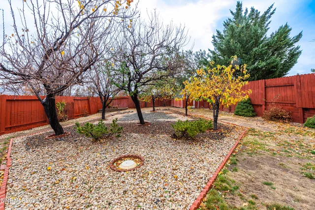 a backyard of a house with barbeque oven