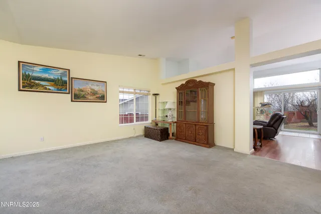 a view of a livingroom with furniture and an empty room