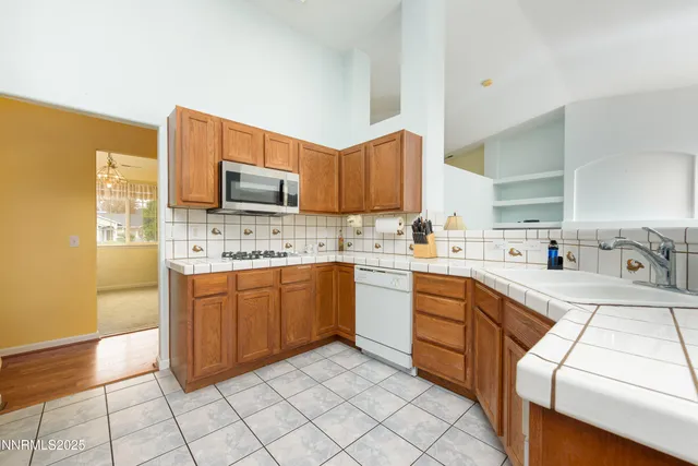 a kitchen with stainless steel appliances granite countertop a sink and cabinets