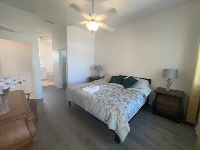 a bedroom with a bed and a chandelier