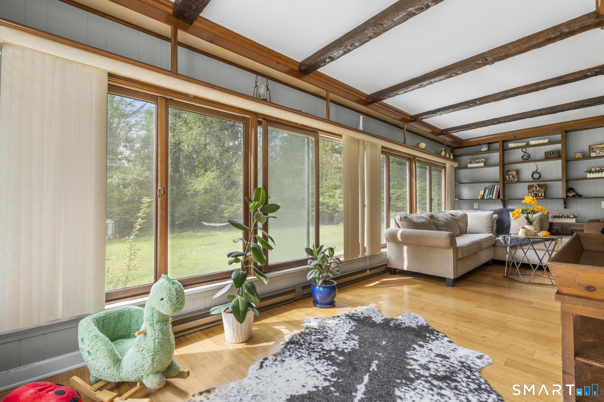 15 Pent Road Deep River, CT 06417 - Photo 16 of 36 a living room with furniture and floor to ceiling windows