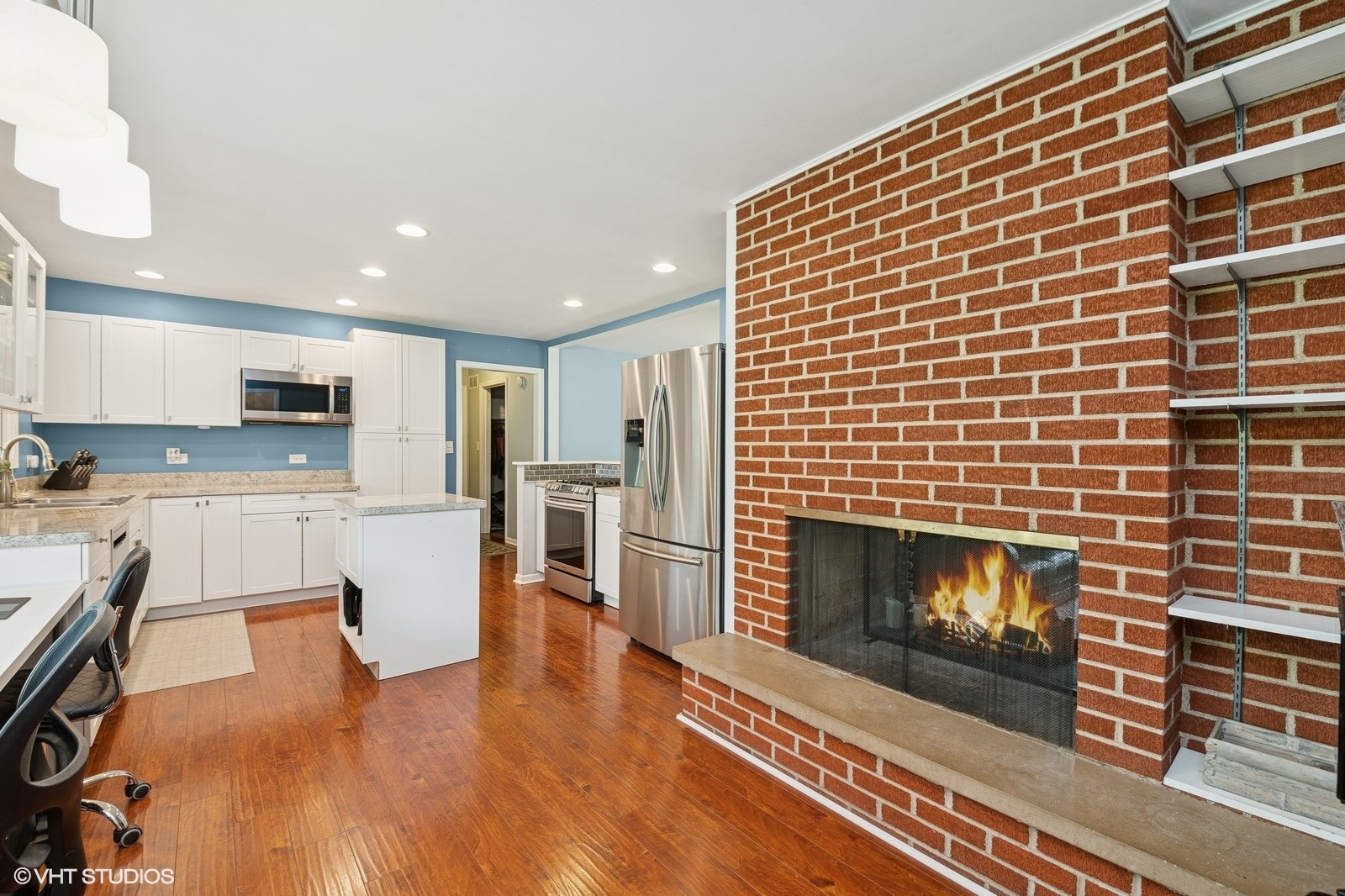 1301 Little John Drive Elgin, IL 60120 - Photo 14 of 33 a living room with stainless steel appliances wooden floor windows and a kitchen view