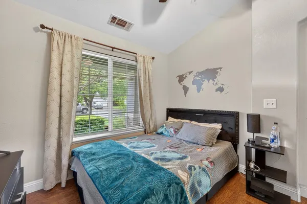 a bedroom with a bed and a window