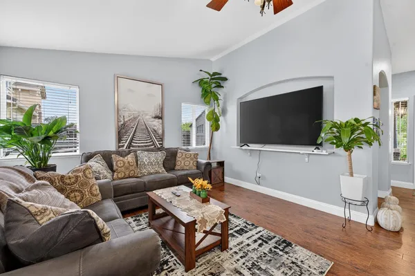 a living room with furniture and a flat screen tv