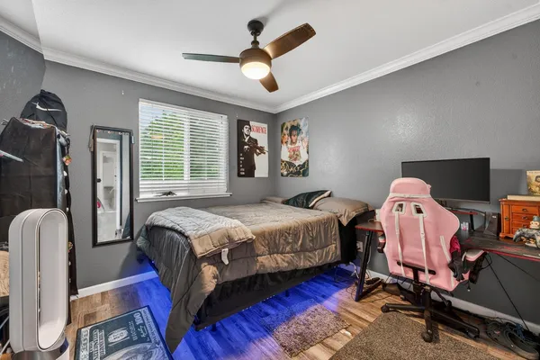 a bedroom with a bed dresser and a window