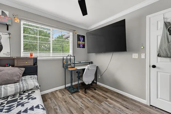 a work room with furniture and a flat screen tv