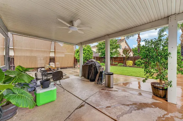 a living room with patio furniture and a garden